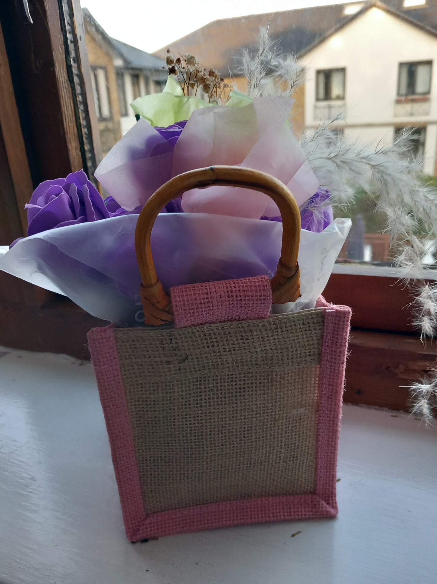 PURPLE SOAP ROSES IN PINK JUTE BAG