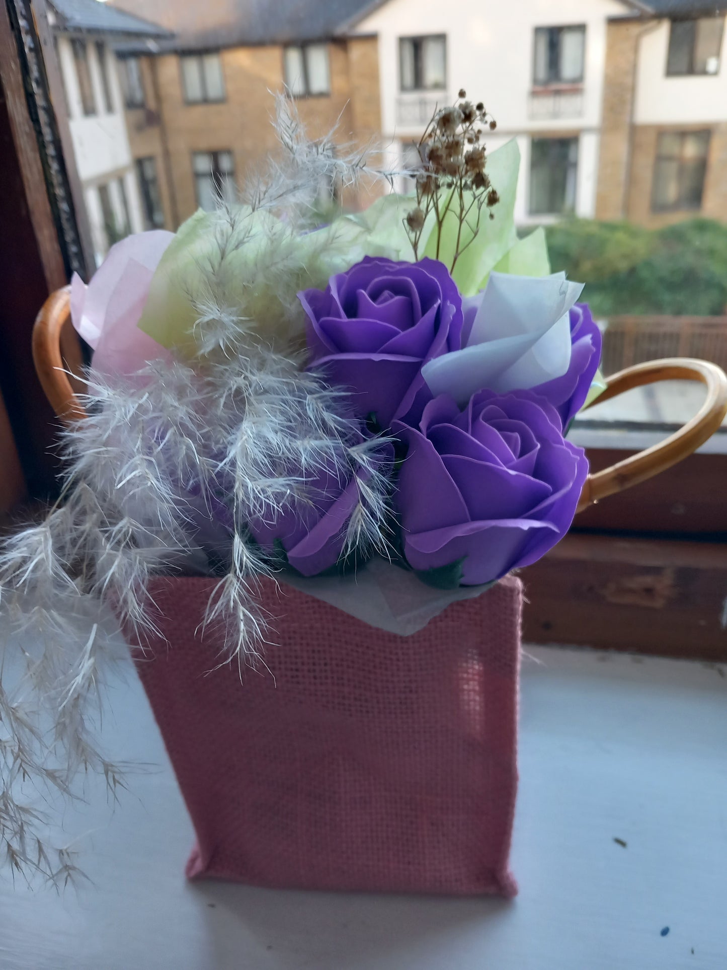 PURPLE SOAP ROSES IN PINK JUTE BAG