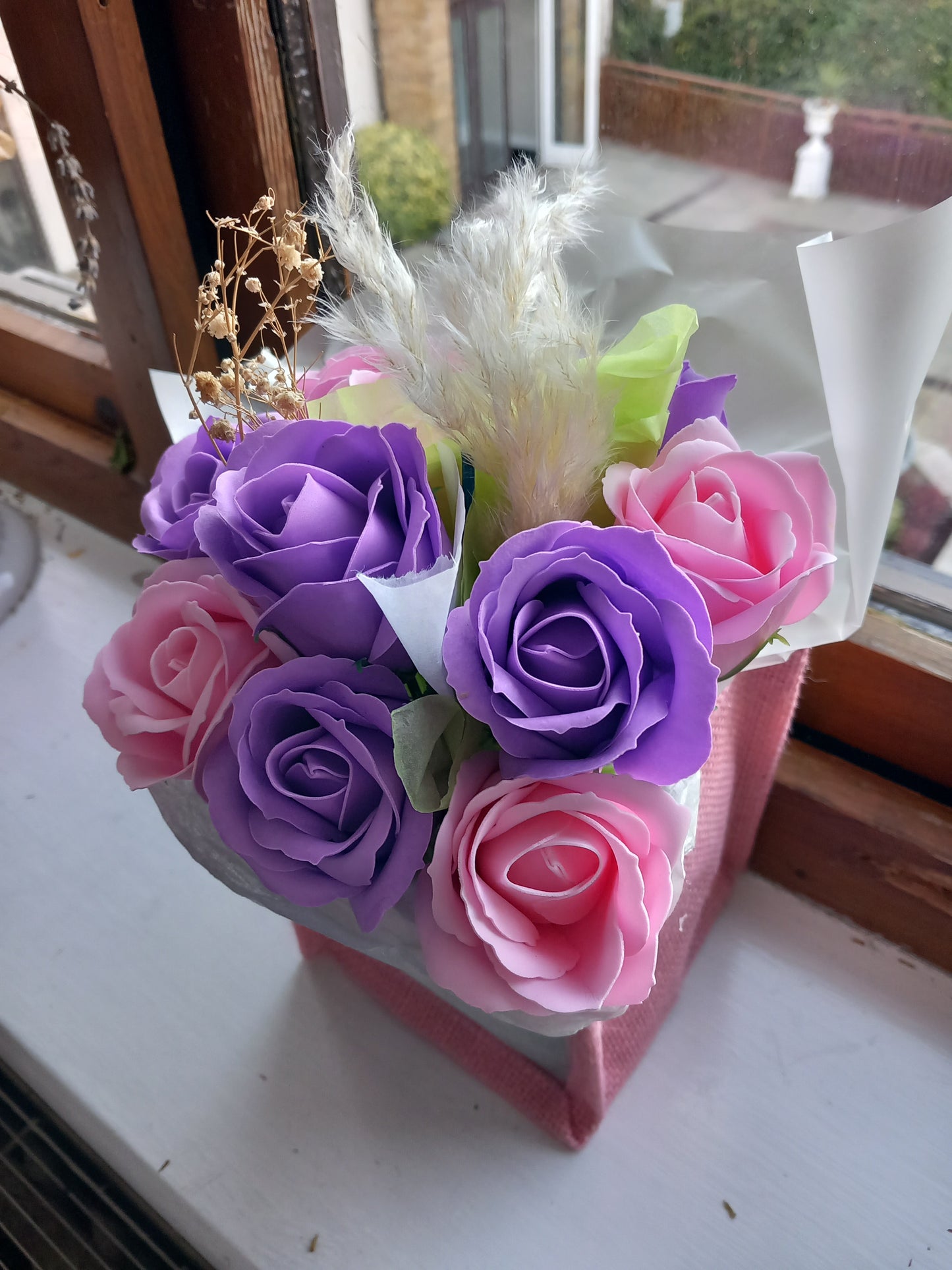 PURPLE AND PINK SOAP ROSES IN PINK JUTE BAG