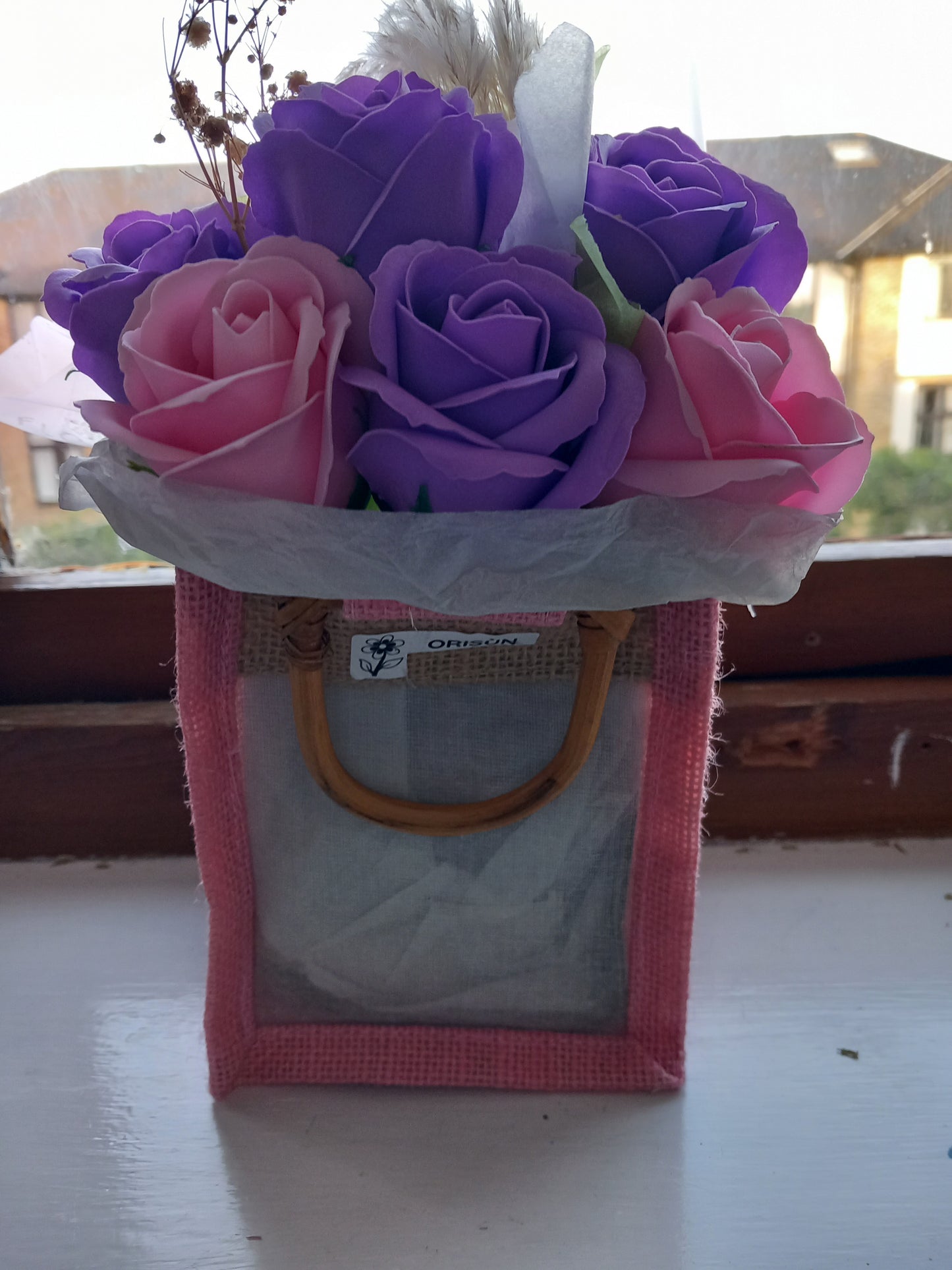 PURPLE AND PINK SOAP ROSES IN PINK JUTE BAG
