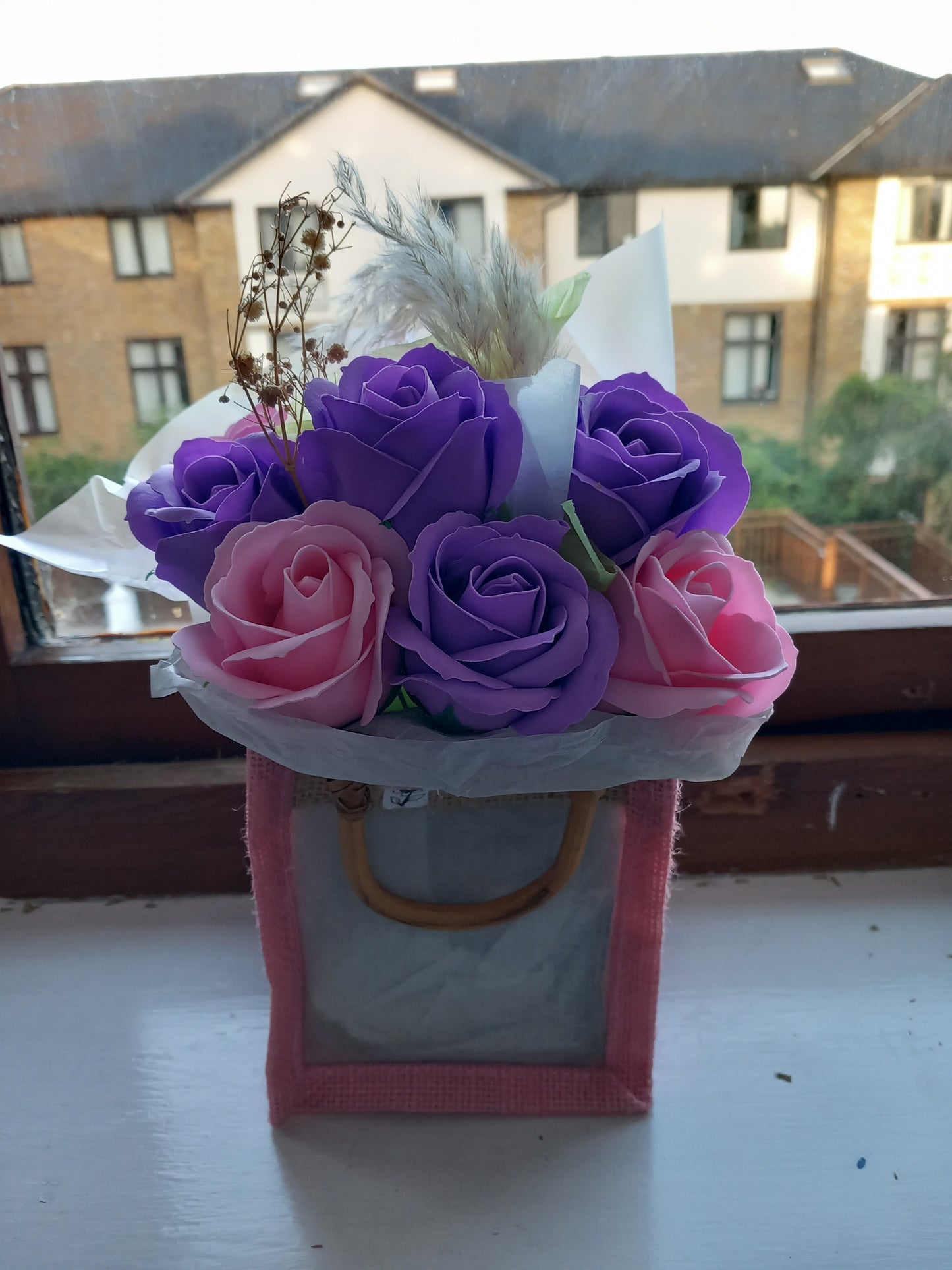 PURPLE AND PINK SOAP ROSES IN PINK JUTE BAG