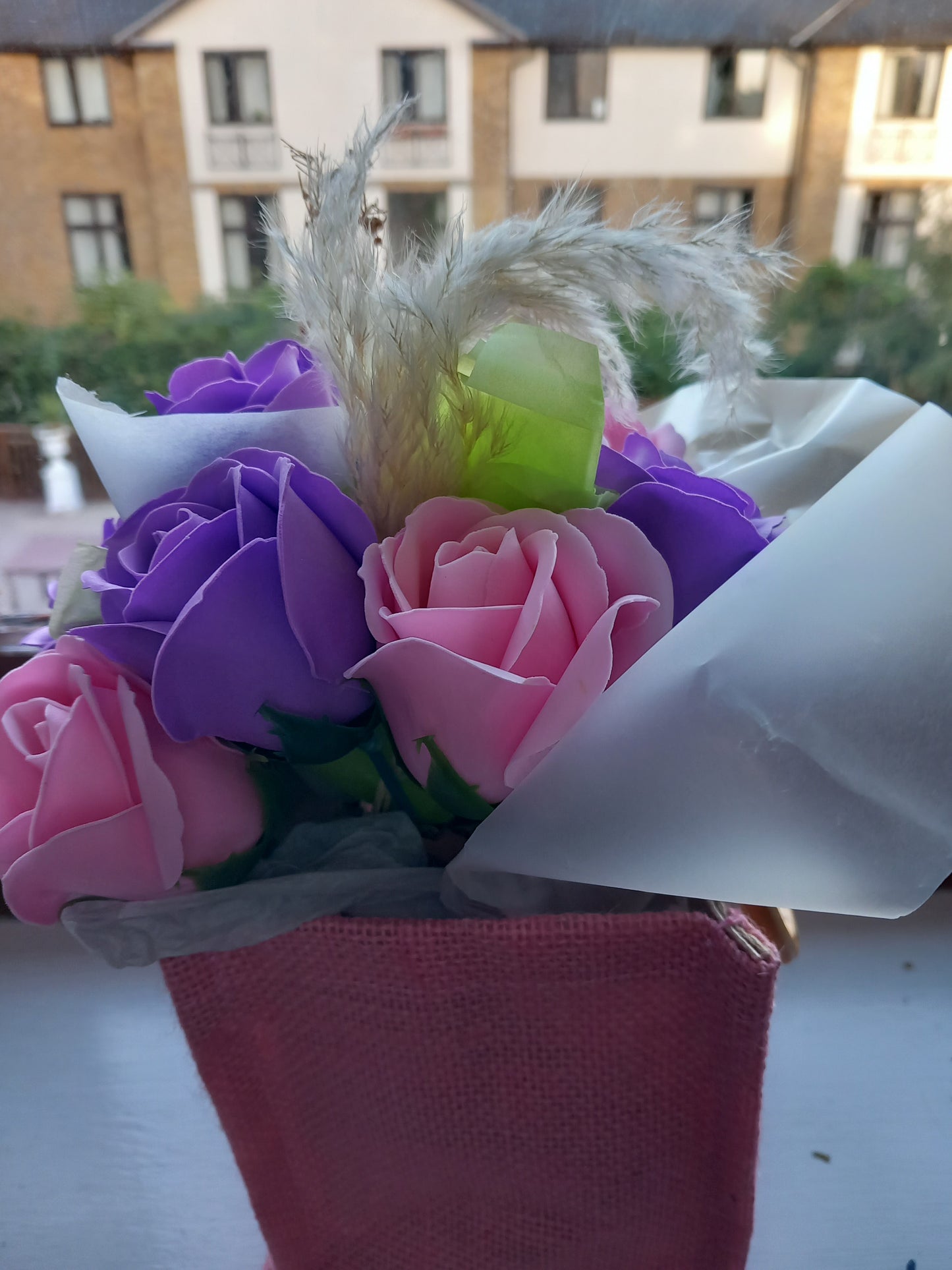 PURPLE AND PINK SOAP ROSES IN PINK JUTE BAG