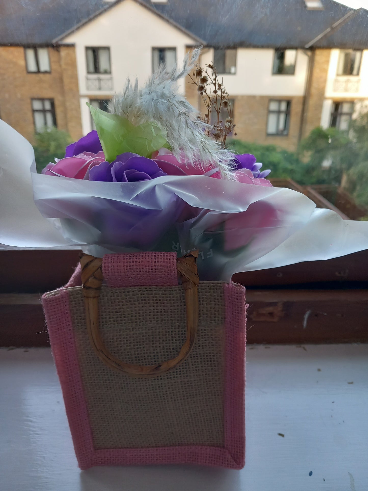PURPLE AND PINK SOAP ROSES IN PINK JUTE BAG